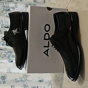A US size 13 black front bucle/lace Aldo shoe.